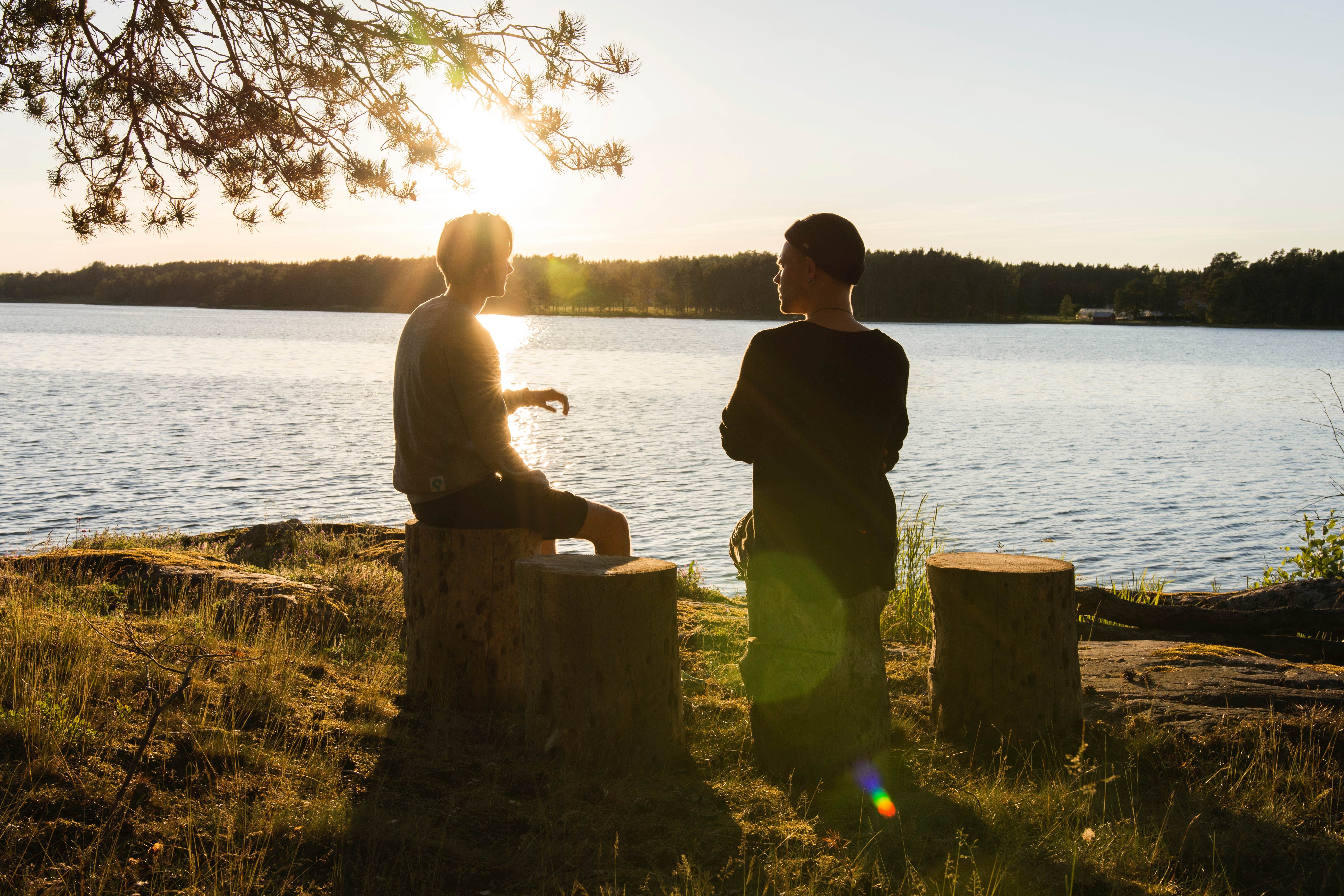 Two young people overlooking a lake at sunset
