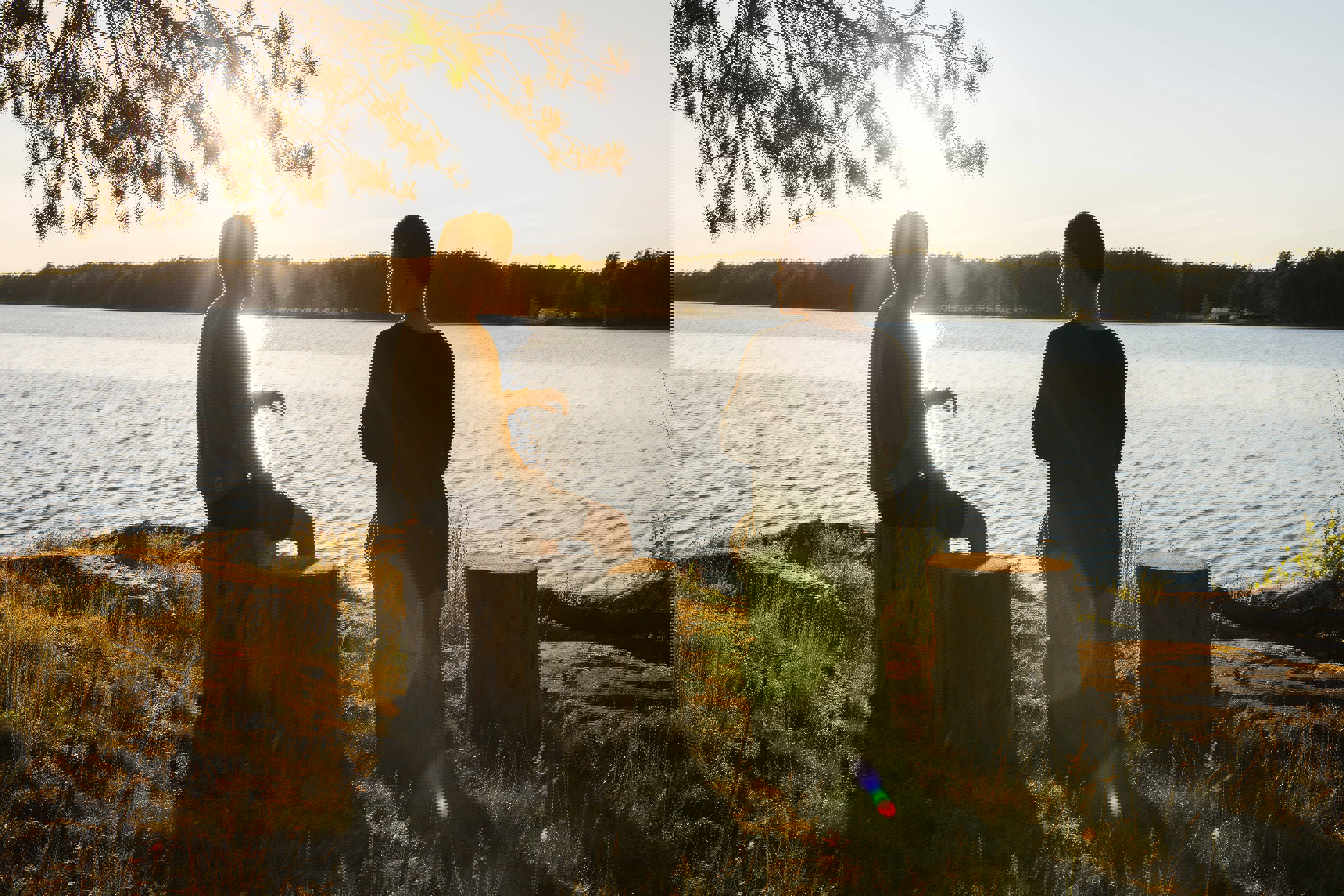 Two young people overlooking a lake at sunset