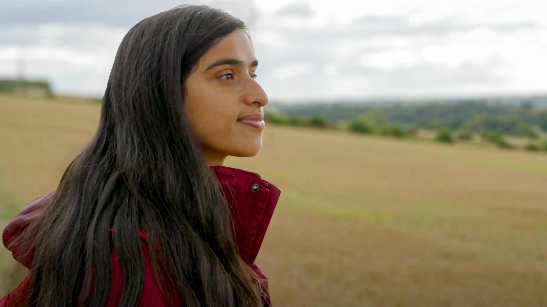 Photo of Annika staring out across a field