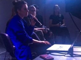 Band Sits Around A Laptop With Microphones