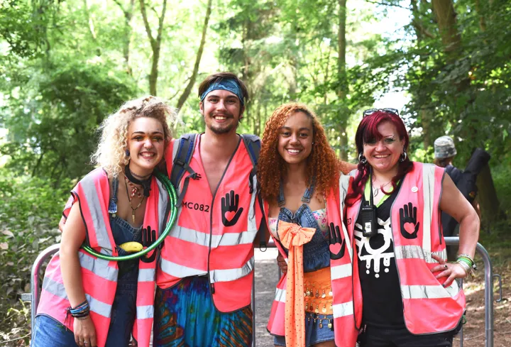 4 festival volunteers smiling 4 festival volunteers smiling