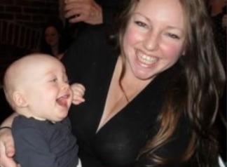 Eve smiling and holding baby