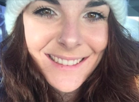 Girl smiling wearing a fluffy white hat