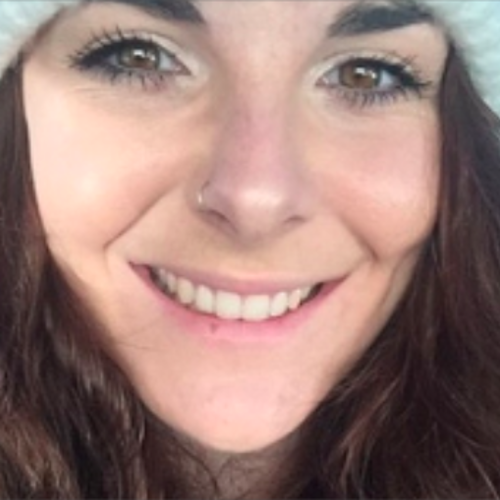 Girl smiling wearing a fluffy white hat