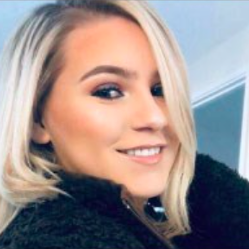 Girl with blonde hair smiling at the camera