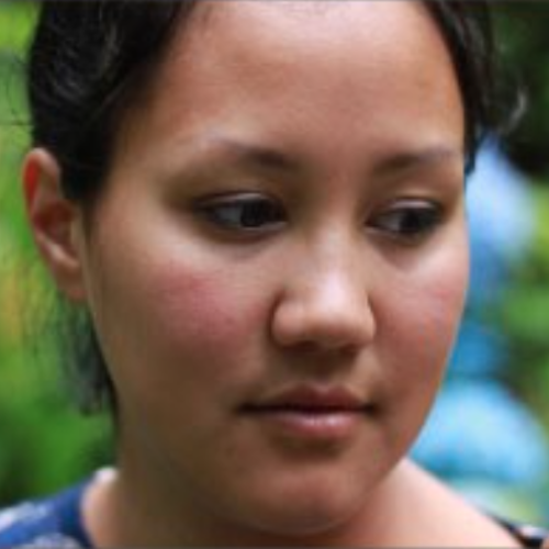 Woman facing the camera looking down and to the right was a content expression