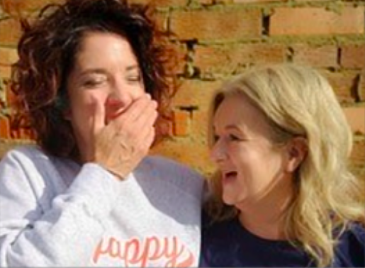 Two females laughing together