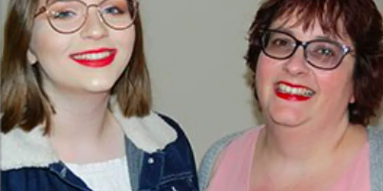 a young and a middle aged female smiling standing next to each other a young and a middle aged female smiling standing next to each other