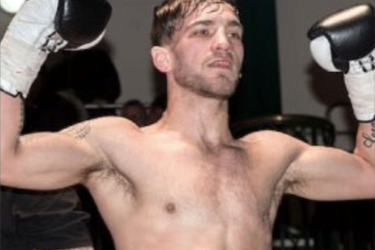 male lifting hands hands in the air, wearing boxing gloves