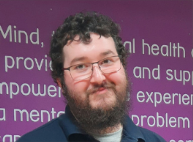 male smiling wearing glasses and beard
