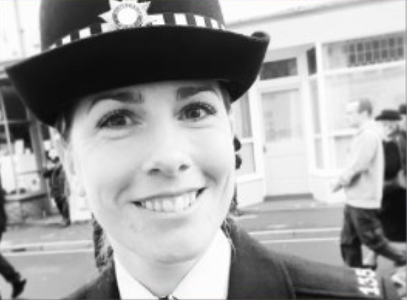 female police officer smiling, black and white photo 
