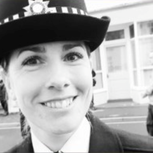 female police officer smiling, black and white photo 