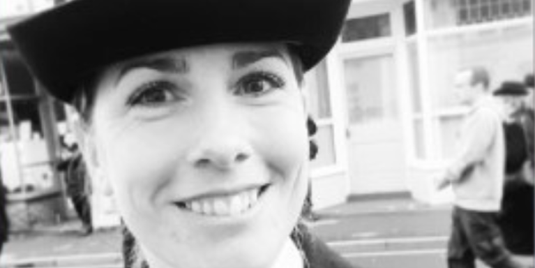 female police officer smiling, black and white photo 