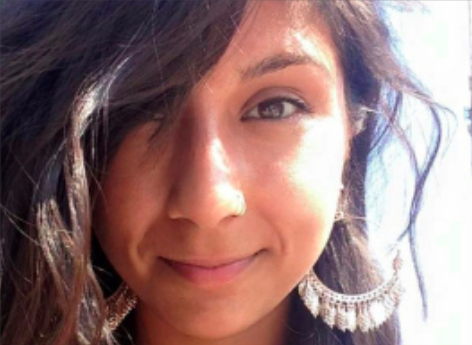 female smiling with large hoop earrings 