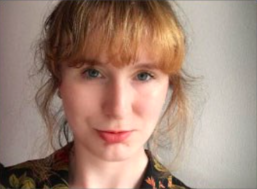 female smiling with a full fringe