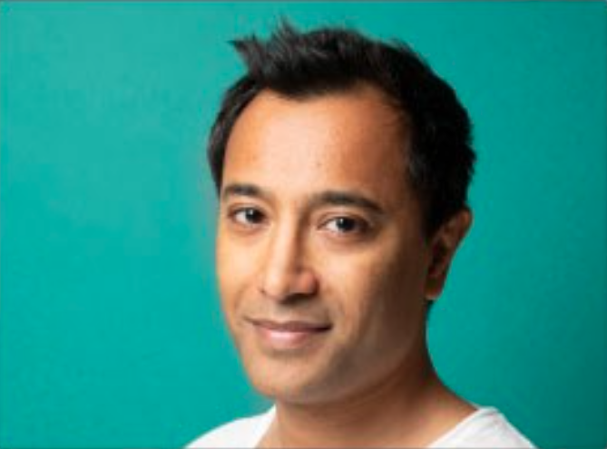 male smiling with a teal background