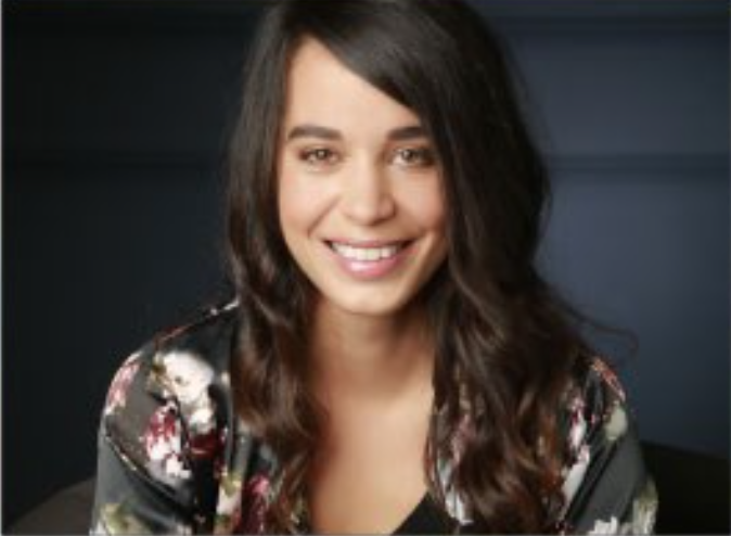 female smiling wearing a flower top