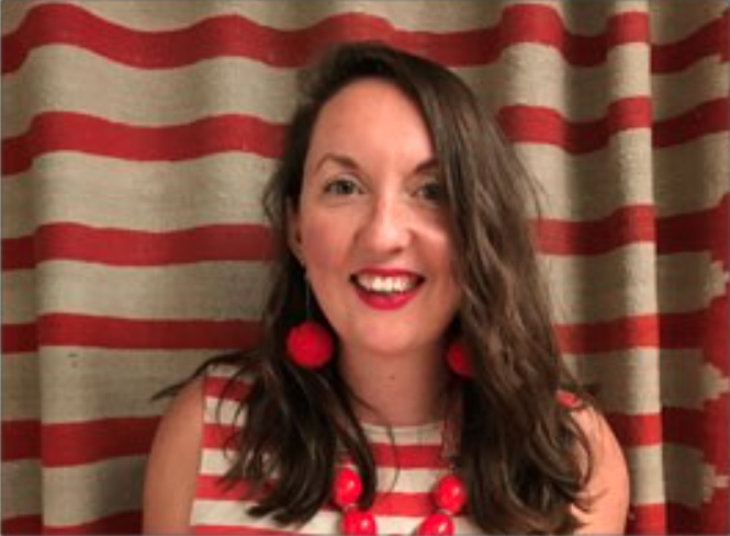 female wearing a white and red striped top, matching the curtain behind her