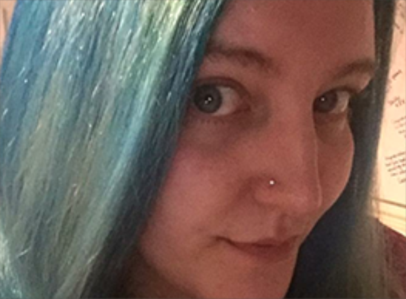 female with blue hair smiling