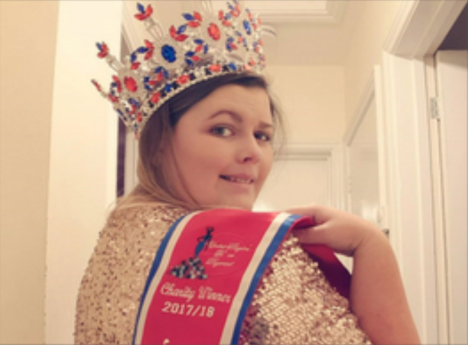 female wearing a sash and crown with blue and red embellishments