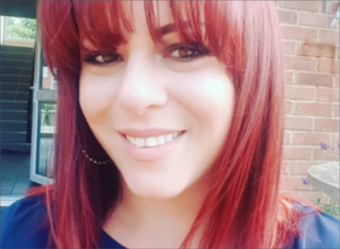 female smiling, with a full fringe and red hair