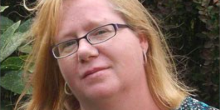 female wearing glasses smiling