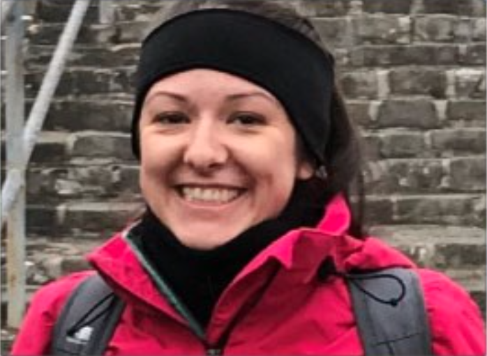 female smiling wearing warm weather clothing