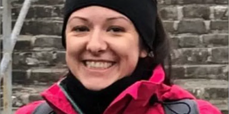 female smiling wearing warm weather clothing