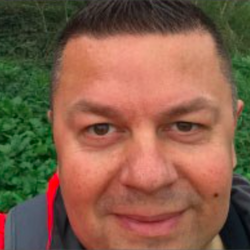 male smiling wearing a high vis jacket