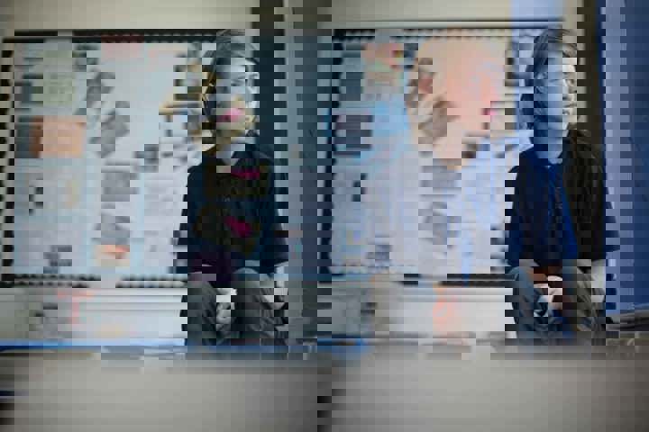 Young person looking out of classroom window