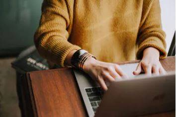 Person typing on a laptop at a desk