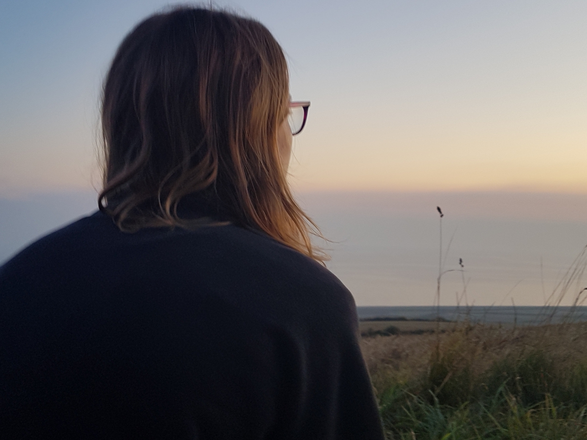Female looking ahead into the distance away from camera