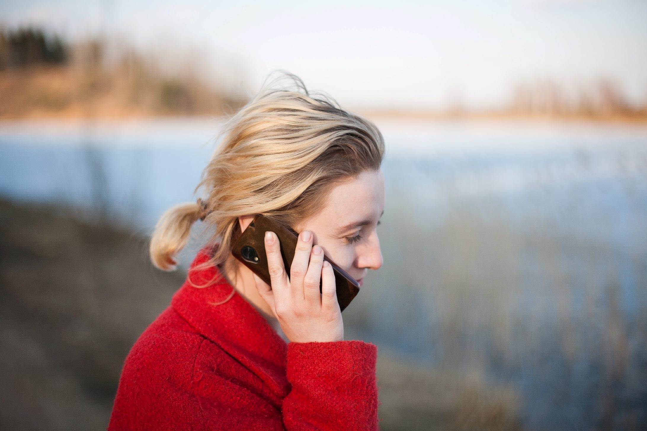 Person in a red coat speaking on the phone