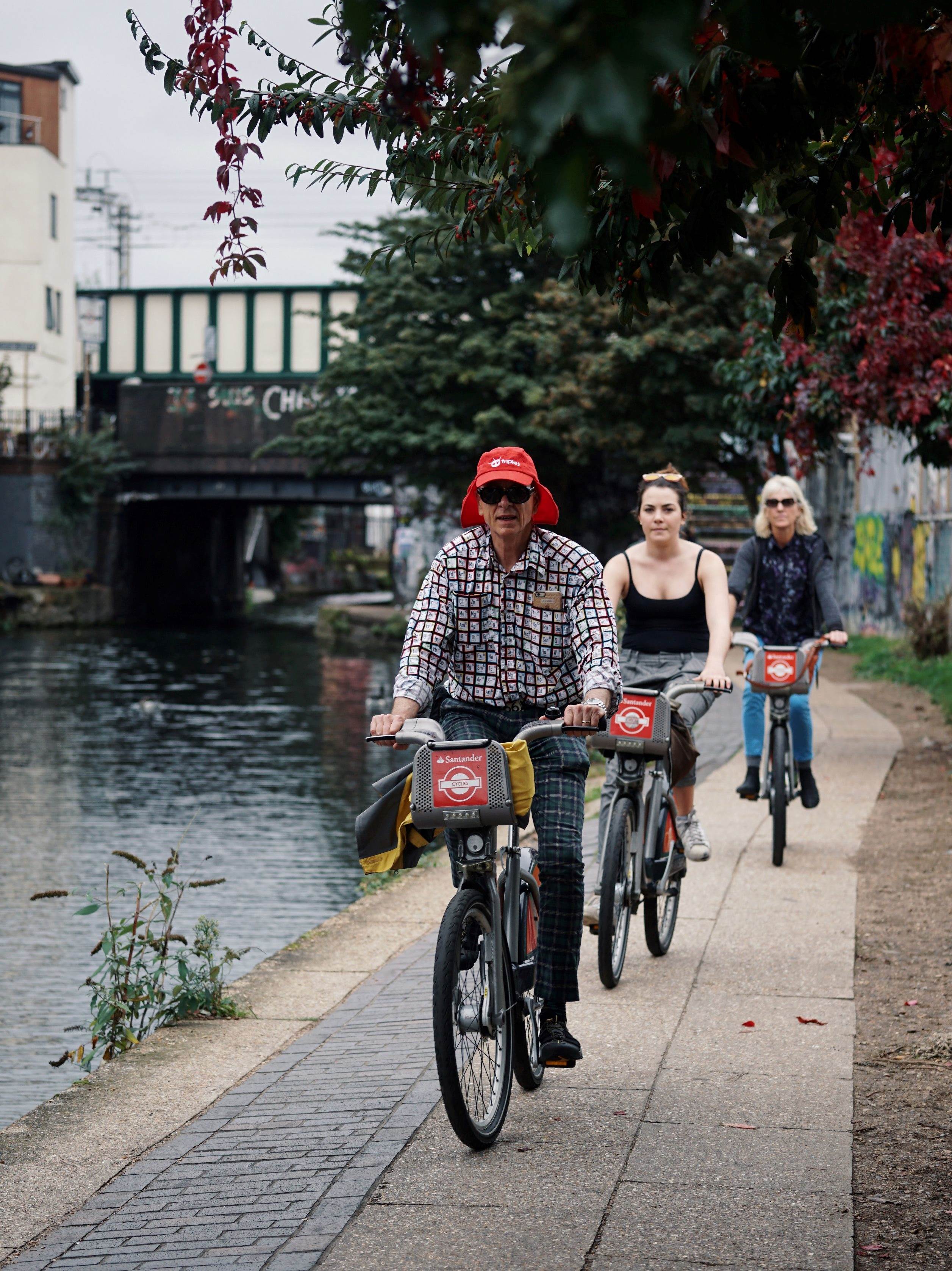Three people bikes canal