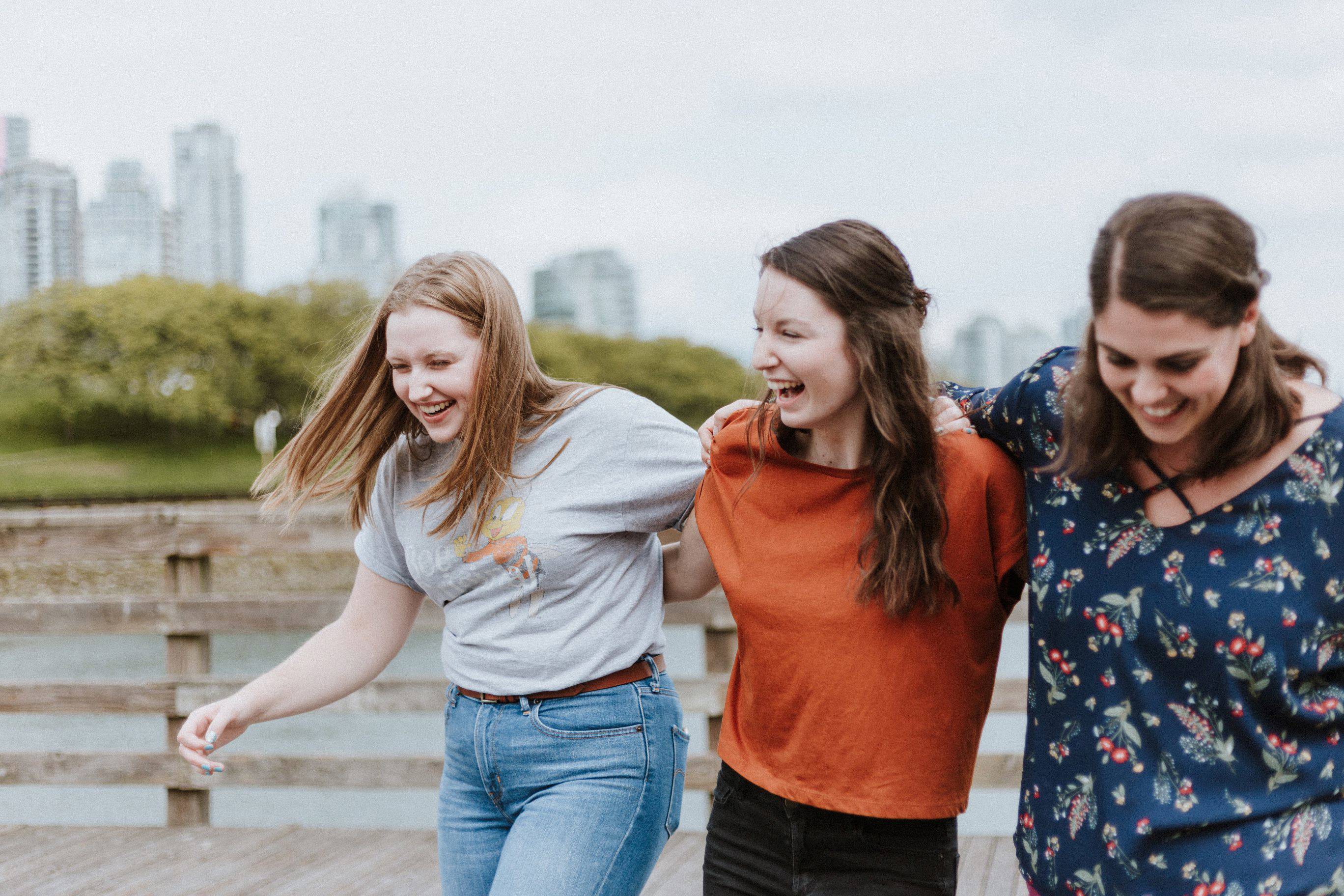 Three people walking and laughing