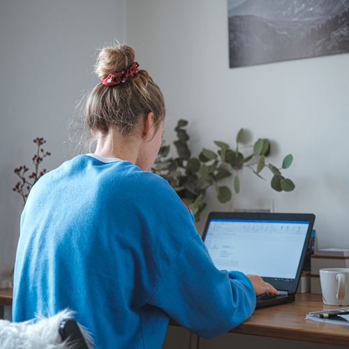 Person at a desk with a blue jumper