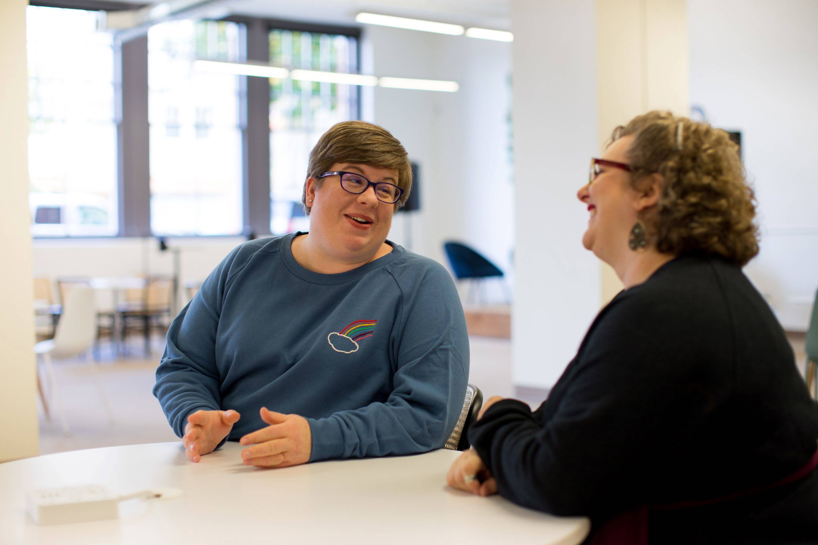Two people talking in an office