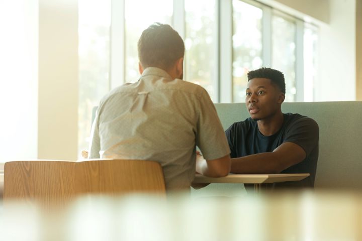 Two people talking over a table