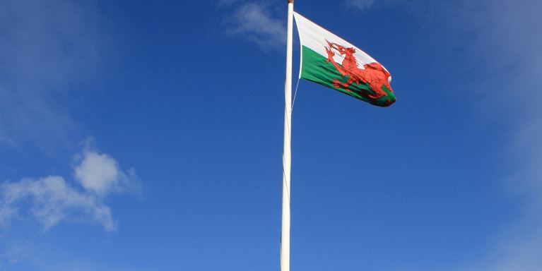 Welsh flag flying above castle 