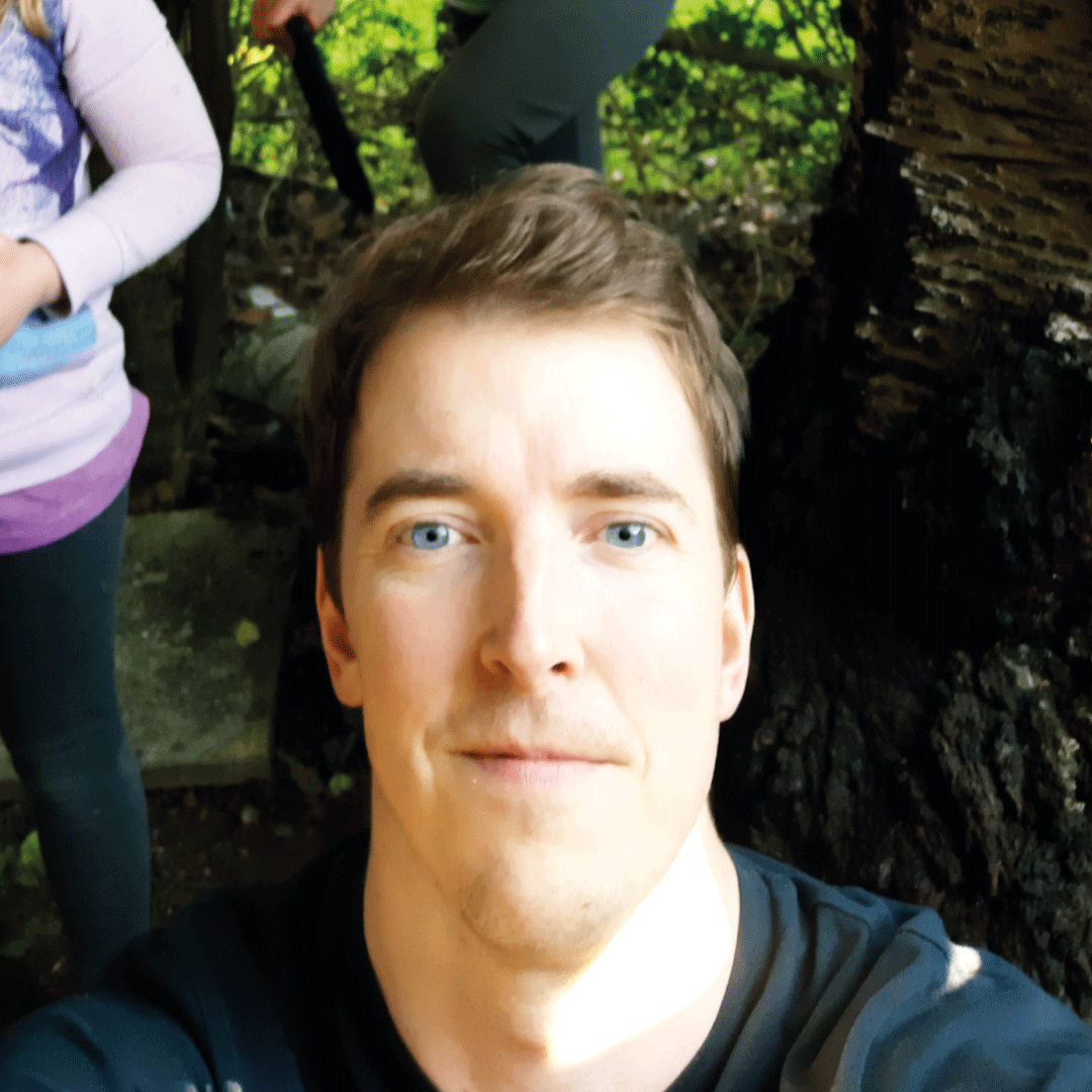 Male with dark hair looking straight at camera