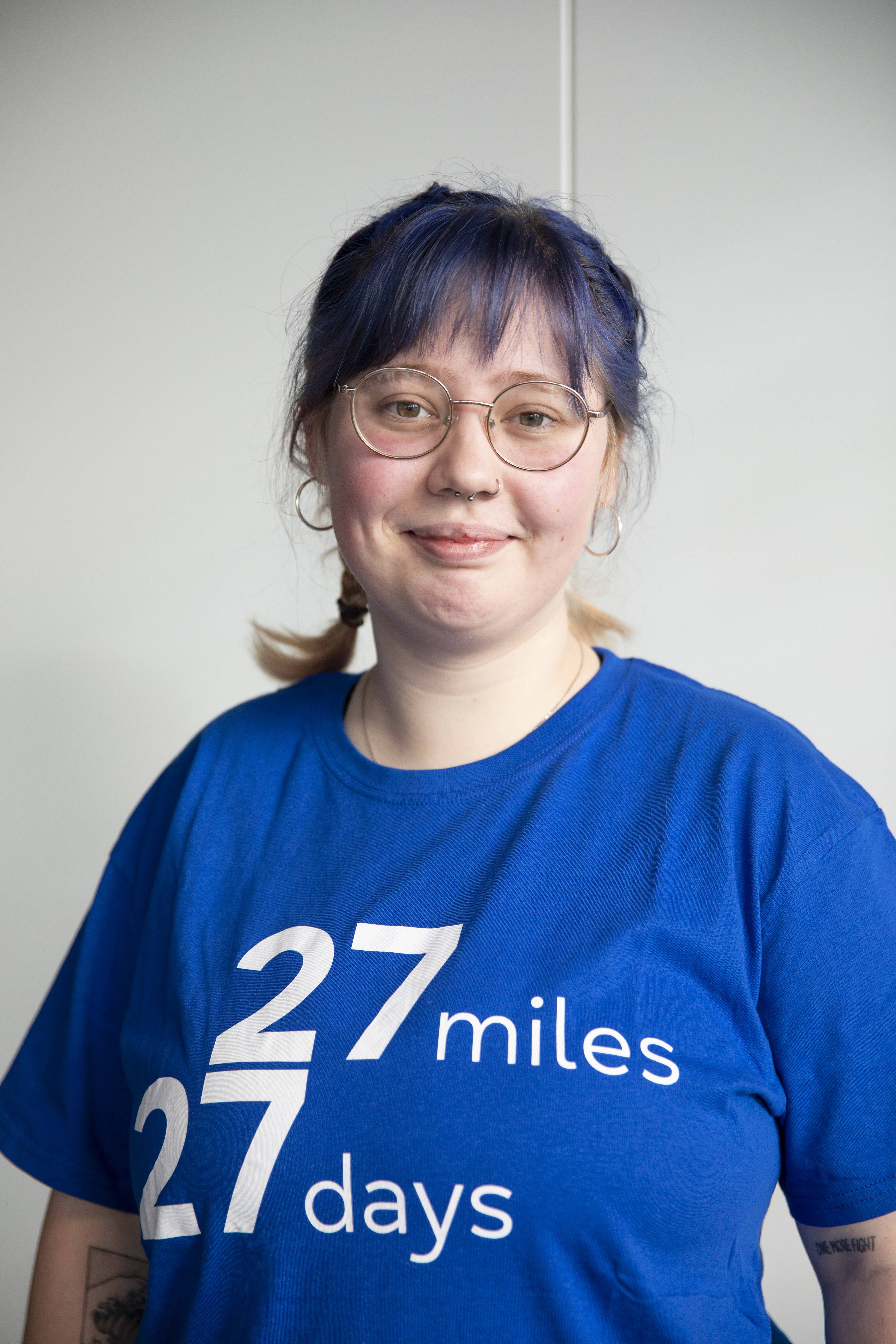 Person looking at the camera wearing a 27 27 t-shirt 
