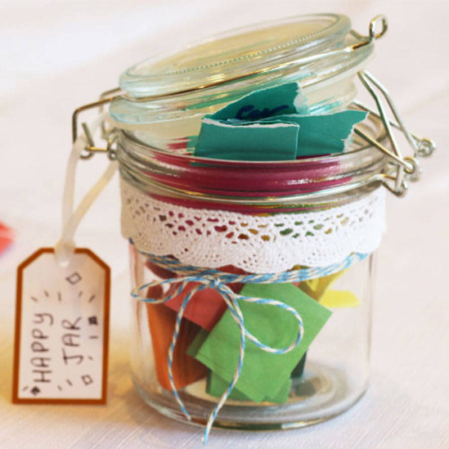 Jar filled with folded pieces of paper, with a tag reading the words 'Happy jar'