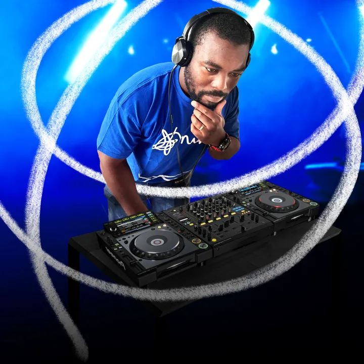 Male in headphones in front of DJ deck Male in headphones in front of DJ deck