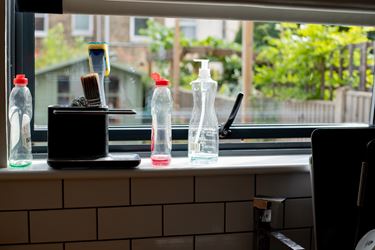 Window sill above sink with empty washing up bottles
