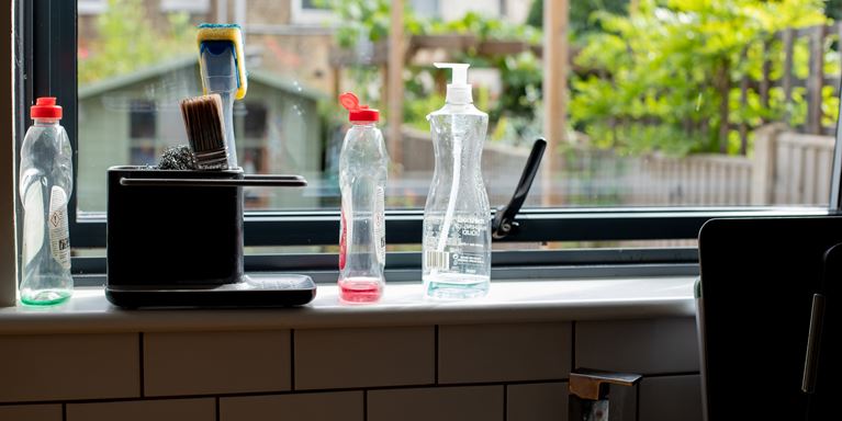 Window sill above sink with empty washing up bottles