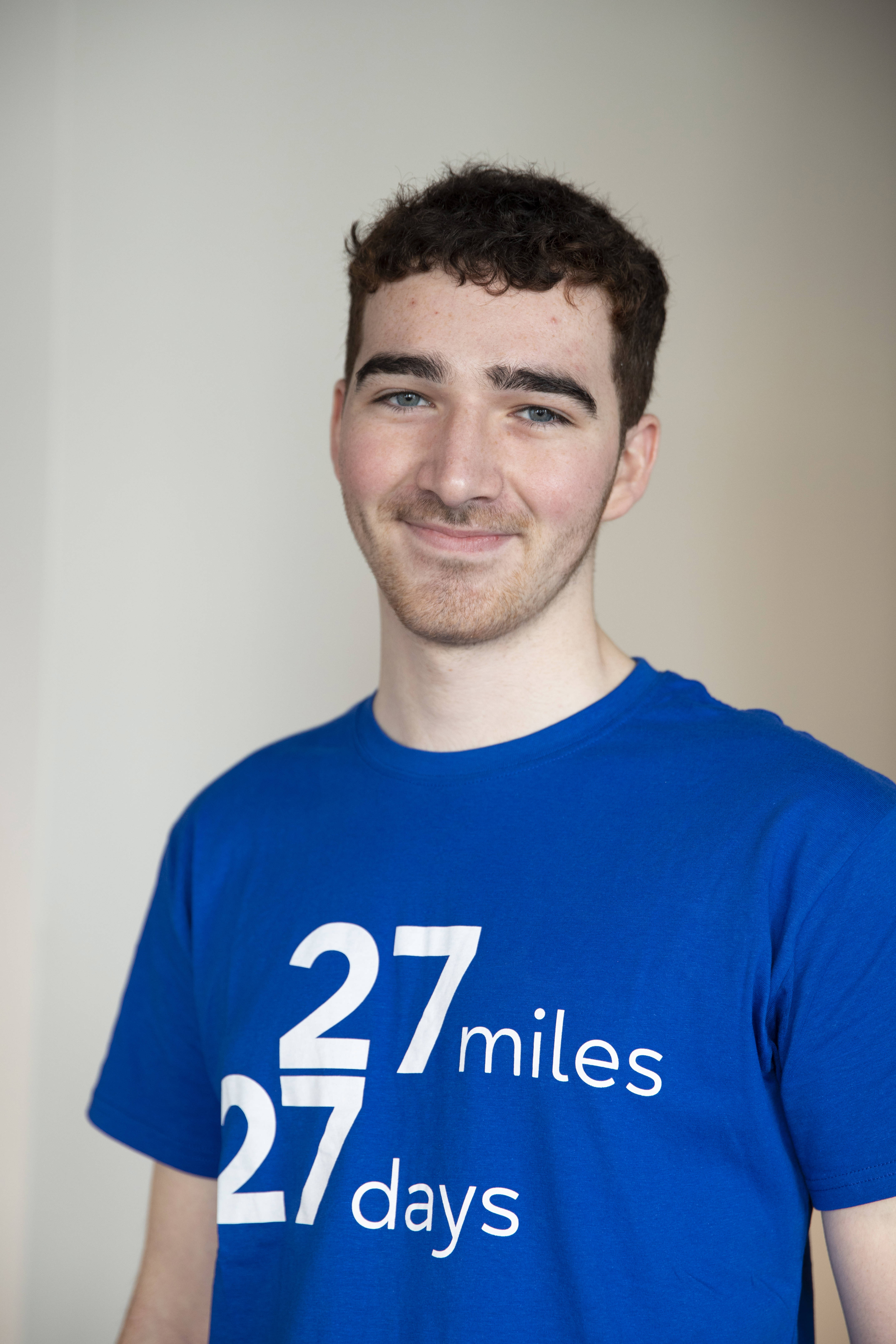 Person looking at the camera wearing a 27 27 t-shirt 