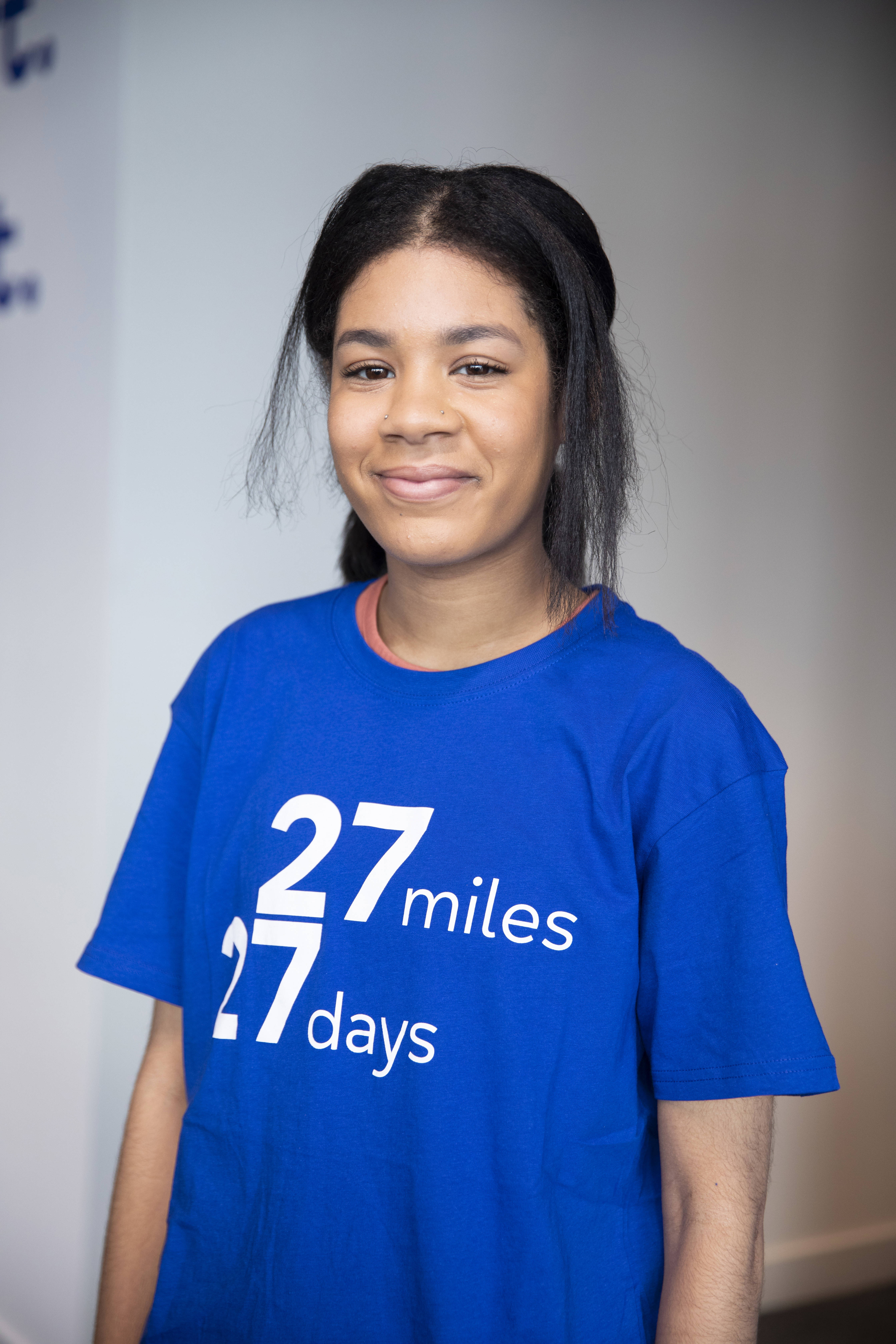 Person looking at the camera wearing a 27 27 t-shirt 