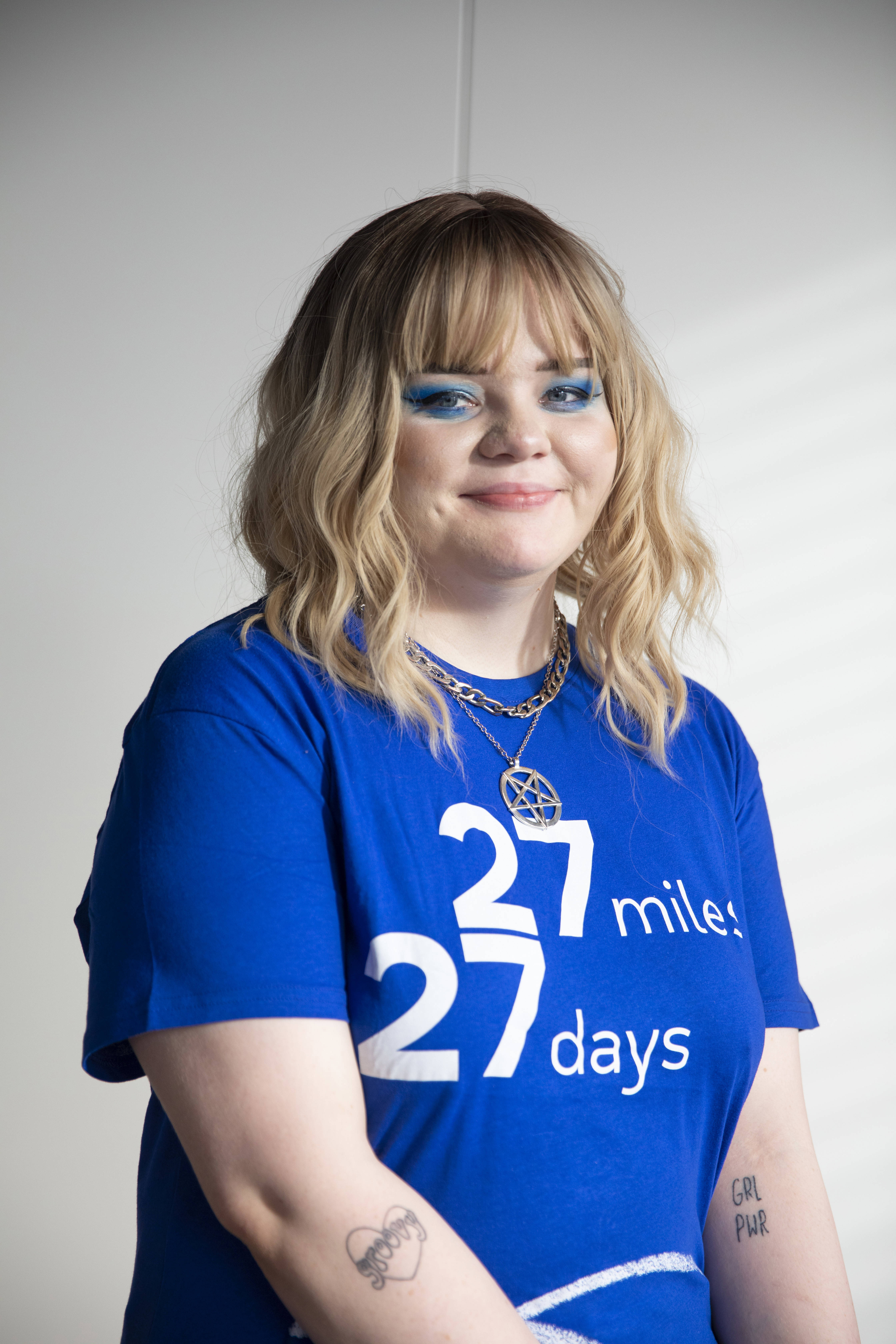 Person looking at the camera wearing a 27 27 t-shirt 