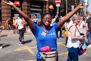 Smiling Mind runner with hands in the air