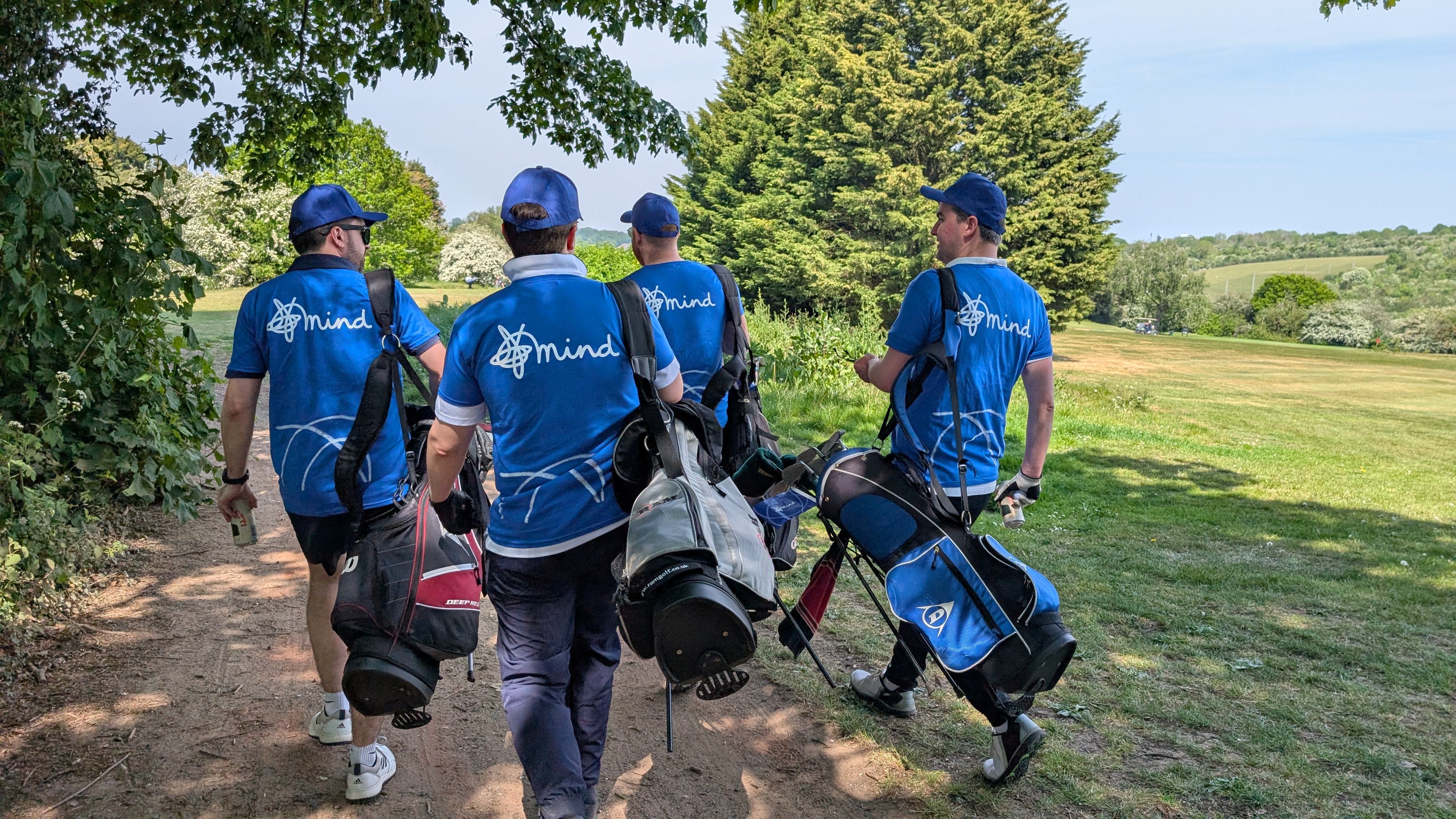 Group of golfers walking with their golf clubs.